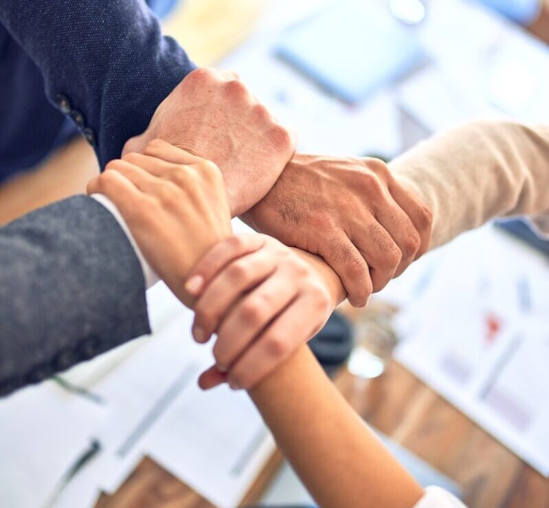 person in black long sleeve shirt holding persons hand